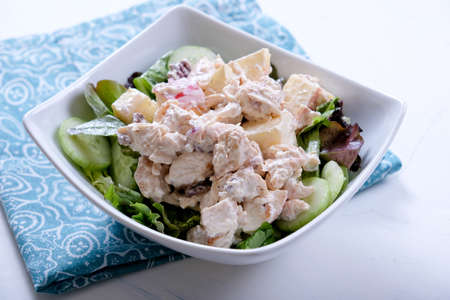 A closeup shot of a fresh salad with chicken and appleの写真素材
