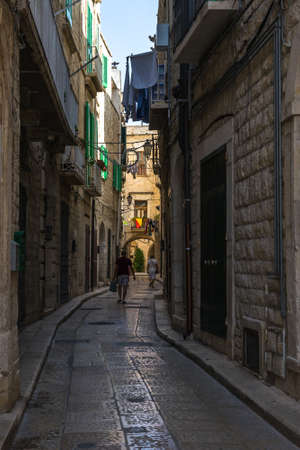 An alleyway in the historic center of Trani, Apulia, Italy at daytimeの写真素材