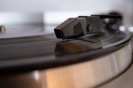 A closeup shot of a cartridge in a portable gramophone with a blurred background