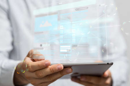 A man holding a laptop and a browser above it