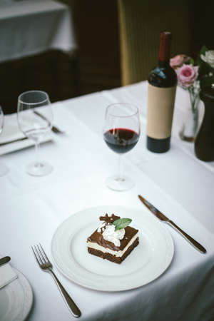 A selective focus shot of a delicious brownie with red wine in a restaurantの写真素材