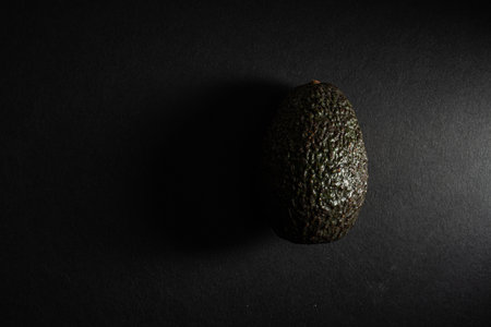 A top view of an avocado on a black surfaceの写真素材