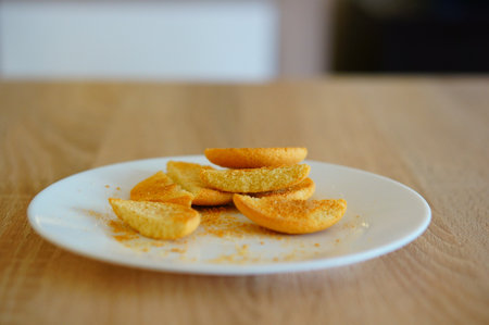 A closeup shot of cookie pieces on a white plate on a wooden surface