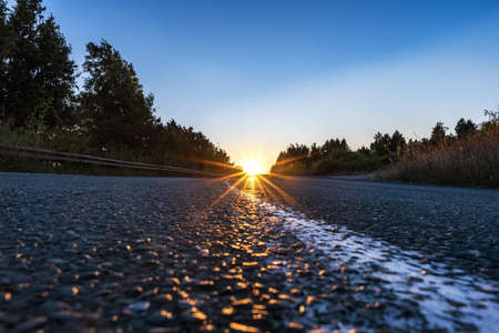 A landscape of the sunset light above the asphalt road