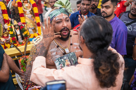 SINGAPORE, SINGAPORE - Feb 08, 2020: Thaipusam is a religious celebration by devotees. Its highlight is a barefoot walk of devotees carrying milk pots and dancing with prickly kavadis.のeditorial素材