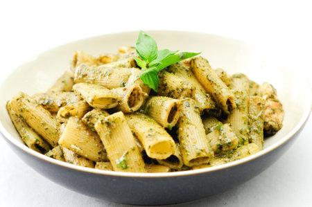 rigatoni pesto pasta with chicken, basil and parmesan cheese andの写真素材