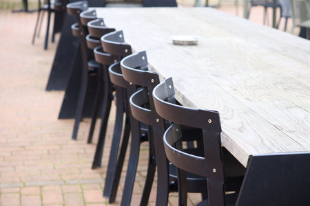 A selective focus shot of chairs around a long wooden table