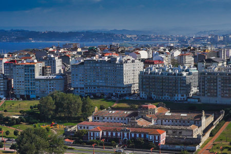 A high angle shot of a lot of buildings by the sea in Coruna, Galicia, Spain