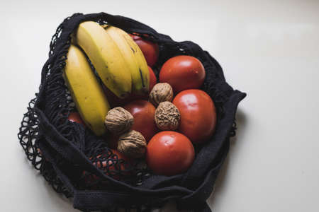 Cloth bag with vegetables on the counterの写真素材