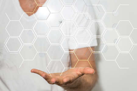 A person presenting a virtual projection of a data structure in the form of honeycombの写真素材