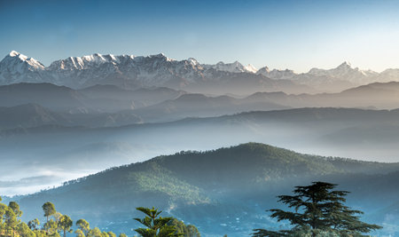 A landscape view of the Himalayan mountain ranges on a clear sky background