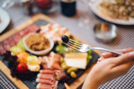 A selective focus shot of delicious meat and cheese platter with wineの写真素材