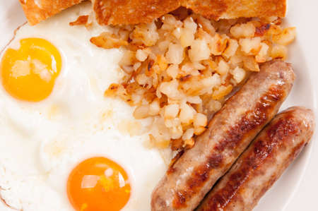 one yellow yolk and one oragnge yolk, eggs with sausageの写真素材
