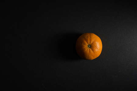 A top view of an orange isolated on a black backgroundの写真素材
