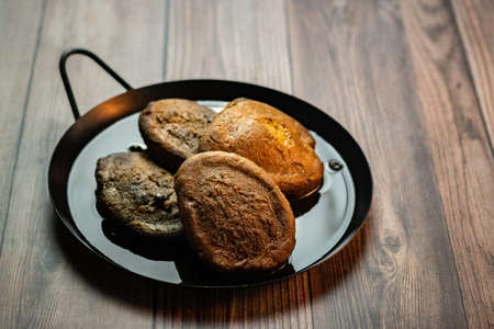 A high angle shot of delicious torrejas de pinol  placed on a plate with a blurred backgroundの写真素材