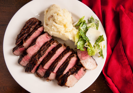 ribeye steak dinner with mashed and caesarの写真素材