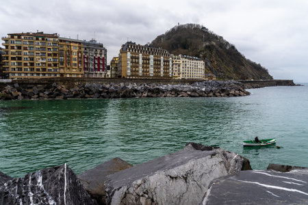 The buildings on the body of the turquoise sea at San Sebastian, Spain on a gloomy dayのeditorial素材