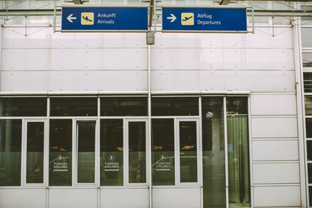A closeup shot of an empty airport with signs and symbols showing the directionの写真素材