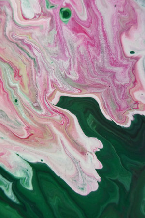 A vertical shot of green pink and white abstract patterns with paints in the water