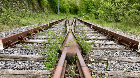 A closeup shot of train rails at the point of the switch