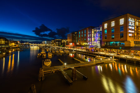 The scenic night view of Trondheim waterfront full of bar cafes and restaurants, Norwayのeditorial素材