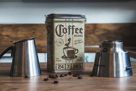 BAD DRIBURG, GERMANY - Feb 22, 2020: A coffee canister surrounded by a Bialetti and some coffee beansのeditorial素材