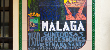 MALAGA, SPAIN - Feb 18, 2020: Decoration with painted tiles advertising for the holy week celebrations in Malaga Spainのeditorial素材