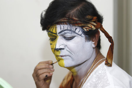 BANGALORE, INDIA - Dec 25, 2019: Local desi male theatre artist doing his makeup for stage performance for christmas celebrationのeditorial素材
