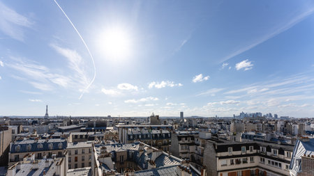 A cityscape of Paris covered in buildings with the Eiffel Tower on the background in Franceのeditorial素材