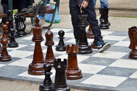 A high angle shot of people playing chess with outdoor wooden figuresのeditorial素材