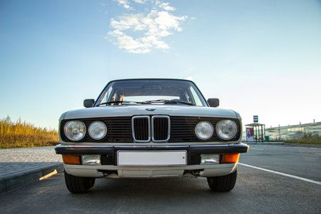 A beautiful shot of a white vintage classic car with round headlights in the roadのeditorial素材