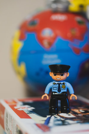 POZNAN, POLAND - Mar 14, 2020: Lego Duplo policeman toy figurine in soft focus background.