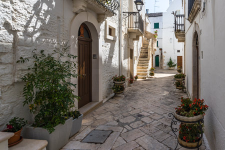 A beautiful outdoor corridor between the white buildings in Locorotondo, Apulia, Italyのeditorial素材
