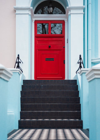 Red entrance door with stairs and blue wallsのeditorial素材