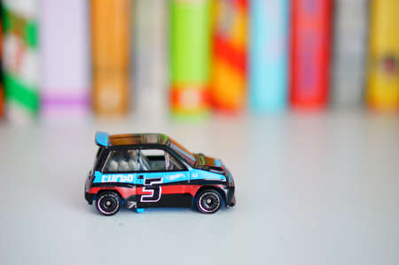POZNAN, POLAND - Mar 12, 2020: Small Mattel Hot Wheels toy Honda car on a shelf with books in soft focus background.のeditorial素材