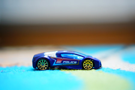 POZNAN, POLAND - Mar 11, 2020: Blue Mattel Hot Wheels Zotic toy futuristic police race car in soft focus background.のeditorial素材