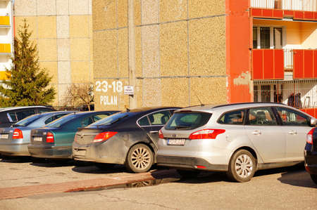 POZNAN, POLAND - Mar 08, 2020: Row of parked cars in front of a apartment building.