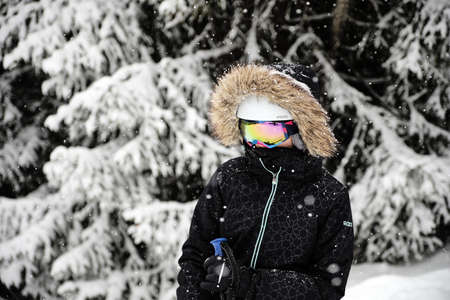 ALPE D'HUEZ, FRANCE - Feb 27, 2020: A closeup shot of a skier wearing fur hooded jacket and goggles at Alpe d Huez ski resort, Franceのeditorial素材