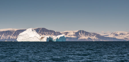 A panoramic shotof a massive iceberg in Disko Island, Greenland