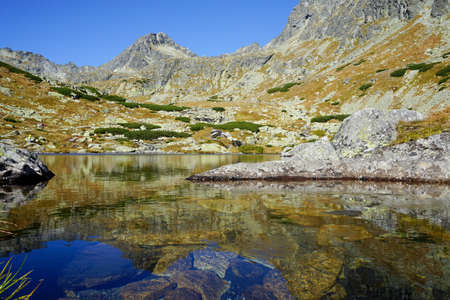 A lake with reflection of mountains in the High Tatras, Slovakia