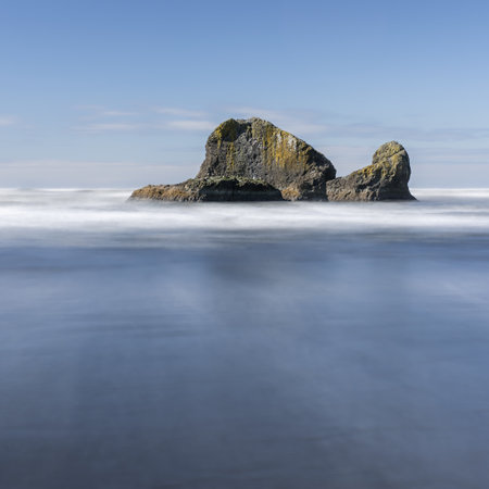 A mesmerizing shot of a huge rock with oceanの写真素材