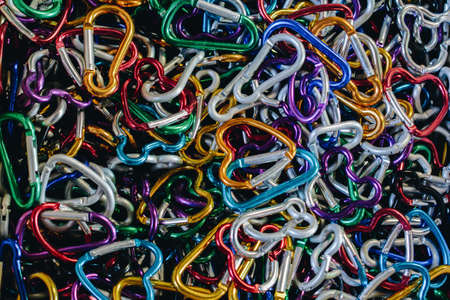 A closeup shot of carabiners of multiple colors
