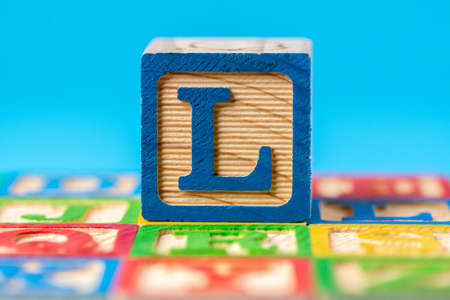 A closeup shot of a colorful, educational alphabet, ABC wooden blocks the letter  in the middleの写真素材