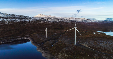 Aerial, drone shot of still windmills, in polar nature, cloudy, autumn sunset, in Narvik, Norway