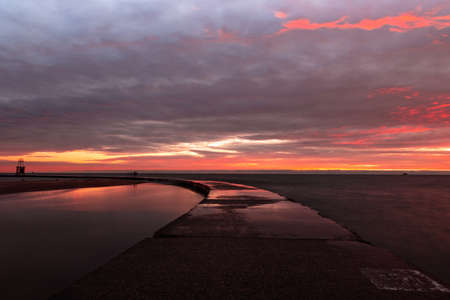 A beautiful view of the sunset piercing through the cloudy sky - great for wallpaperの写真素材