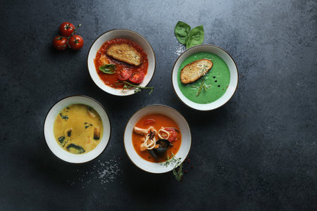 The four kinds of cream soups made of tomatoes, mushrooms, seafood, and basilの写真素材