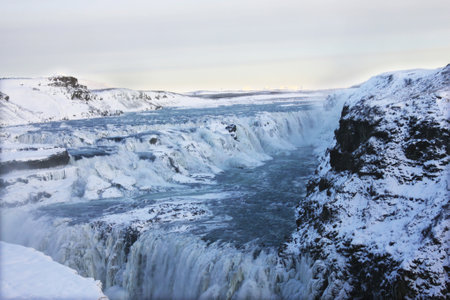 The waterfall of Gullfoss in Iceland, Europe surrounded by ice and snowの写真素材