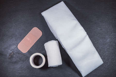A top view closeup of the medical micropore, gauze bandages, and plaster on the table