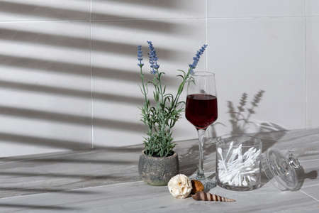 A closeup shot of a glass of wine on the table with plants under the lights - cool for aesthetic...