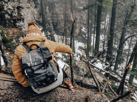 A high angle view of a Caucasian woman dressed appropriately for winter going down the hiking trailの写真素材